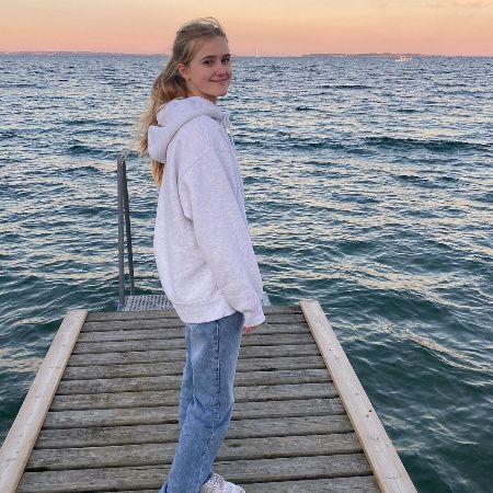 The five feet three inches tall Eva Hauge took a picture on dock. 